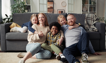 Family sitting in front of a couch