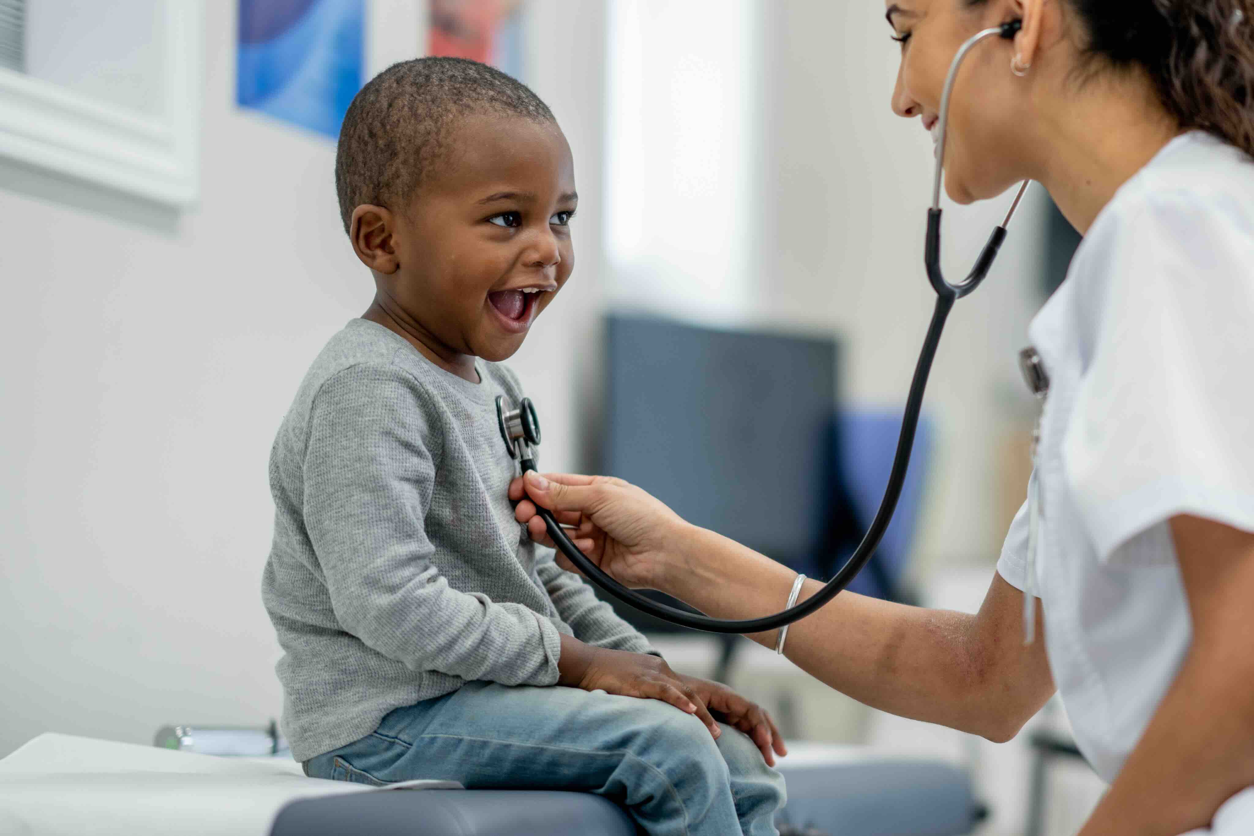 Doctor listening to child's heart